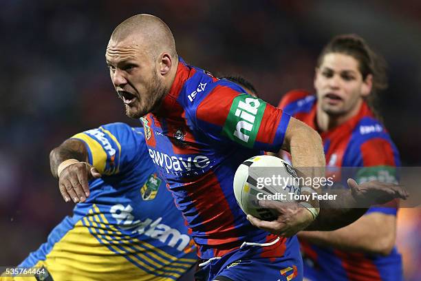 Nathan Ross of the Knights is tackled during the round 12 NRL match between the Newcastle Knights and the Parramatta Eels at Hunter Stadium on May...