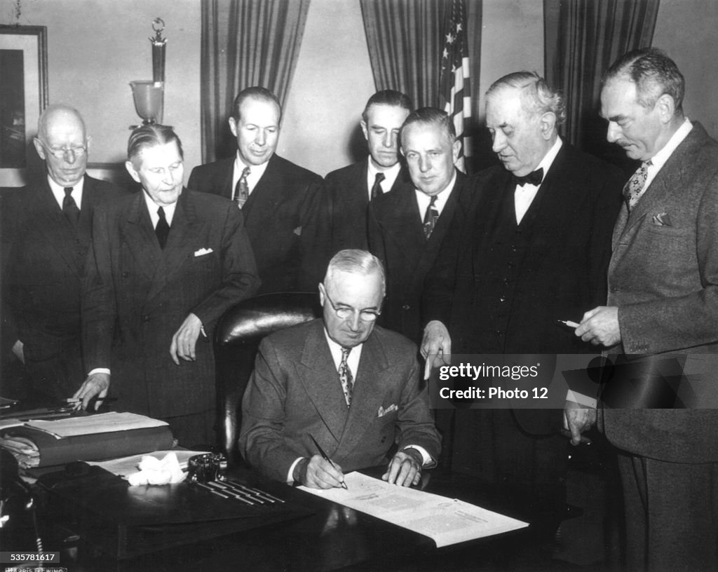 Marshall plan, President Truman signs the Economic Assistance Act, a program for the reconstruction of Europe. (Dean Acheson on the right)April 19, 1949