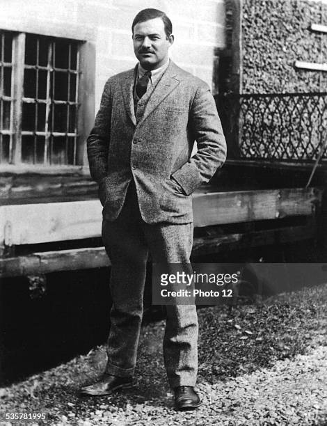 American writer Ernest Hemingway posing in front of his house at 113 rue Notre-Dame-des-Champs, in the 6th arrondissement of Paris, 1924.