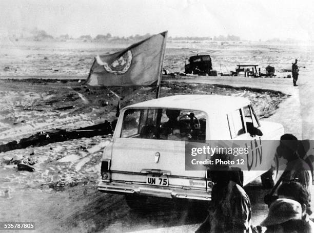 United Nations vehicle passing Israeli troops nearQuantara on the east bank of the Suez Canal., A U.N. Observer was posted on either side of the...