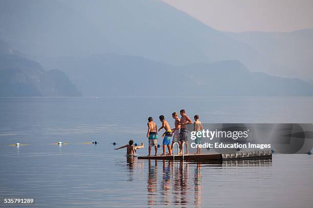 Young boys playing on Slocan Lake, New Denver, Slocan Valley, West Kootenay, British Columbia, Canada.