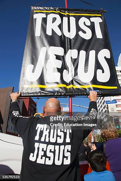 Sign reads 'Trust Jesus' sign, Chinese New Year, Los Angeles, California.