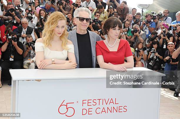 Sarah Gadon, David Cronenberg and Emily Hampshire at the photo call for "Cosmopolis" during the 65th Cannes International Film Festival.