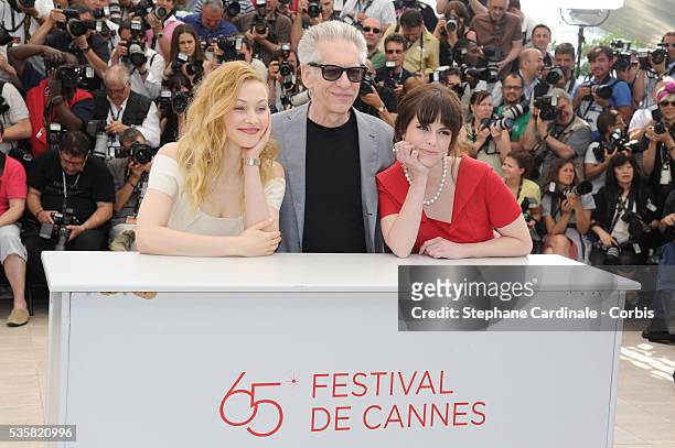 Sarah Gadon, David Cronenberg and Emily Hampshire at the photo call for "Cosmopolis" during the 65th Cannes International Film Festival.