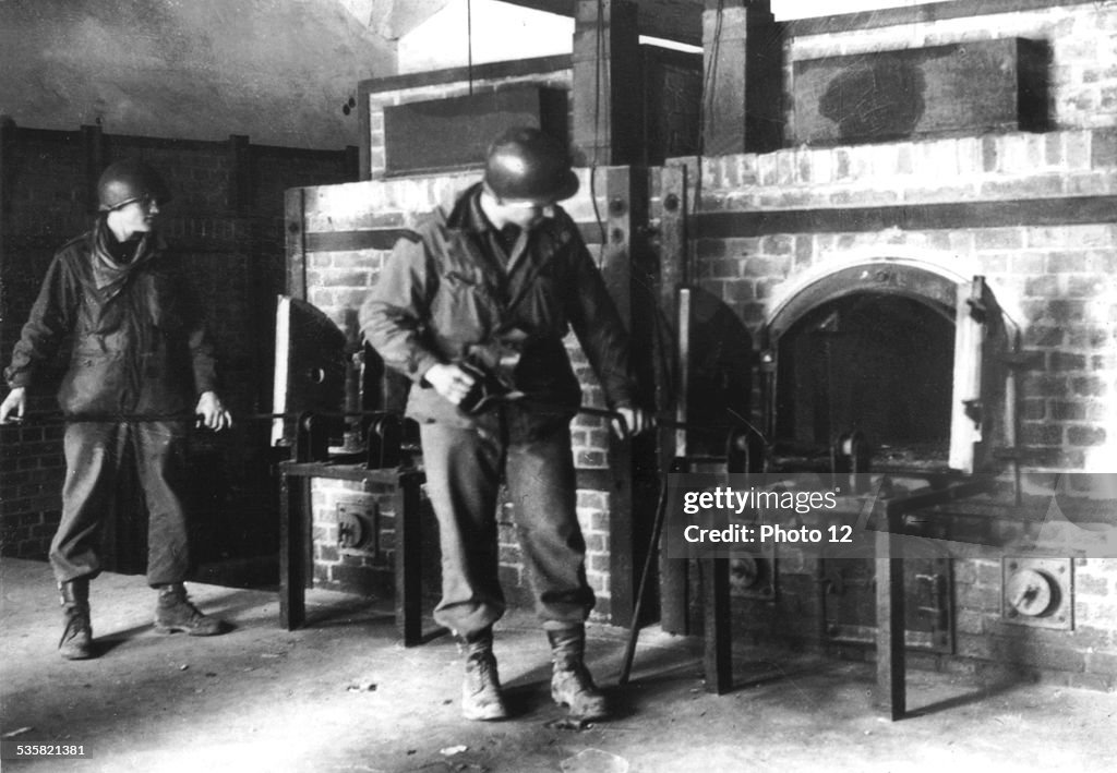 American soldiers by the crematory ovens of Dachau concentration camp