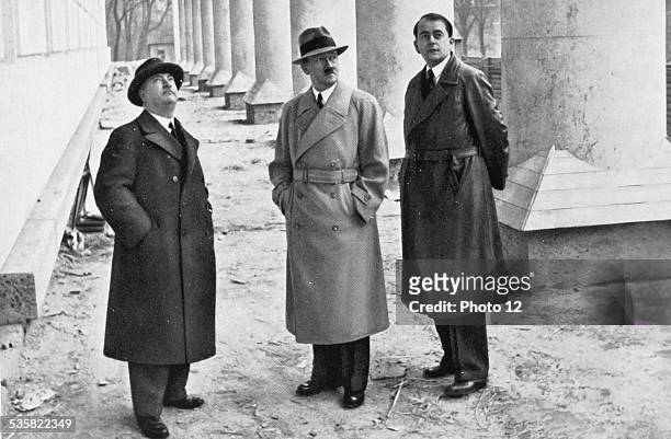 Adolf Hitler, professor Gall and architect Albert Speer visiting the building site of the Fine Arts House, in Munich, Weimar Republic.