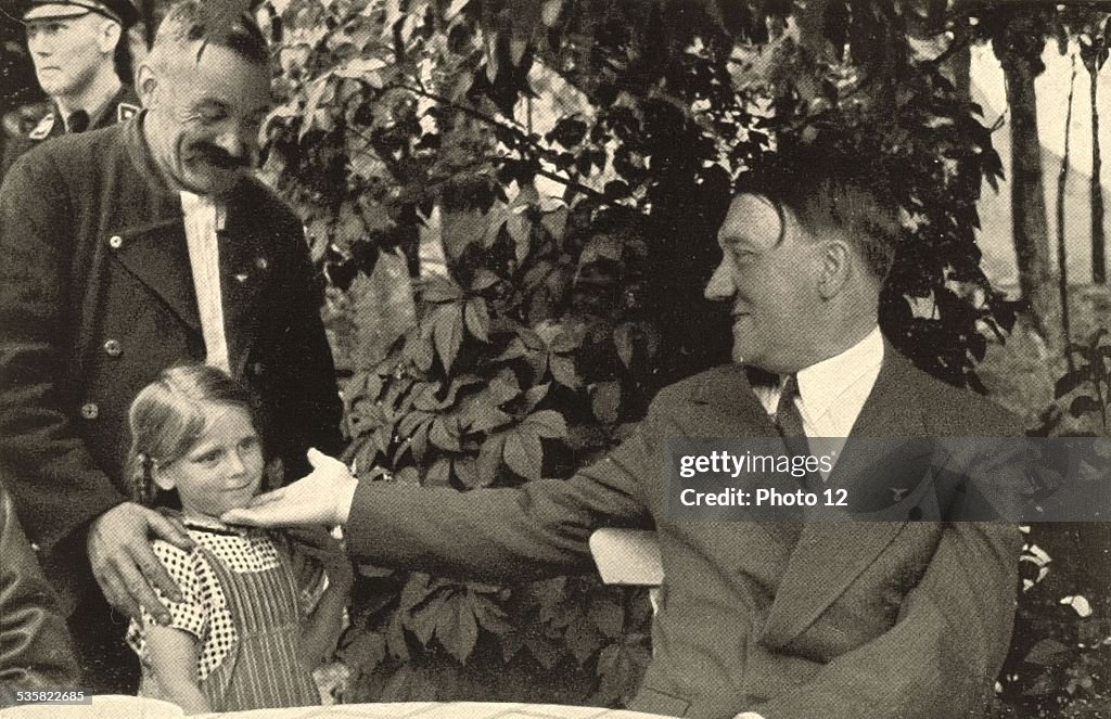 Hitler, on holiday in Obersalzberg, greeted by a local family