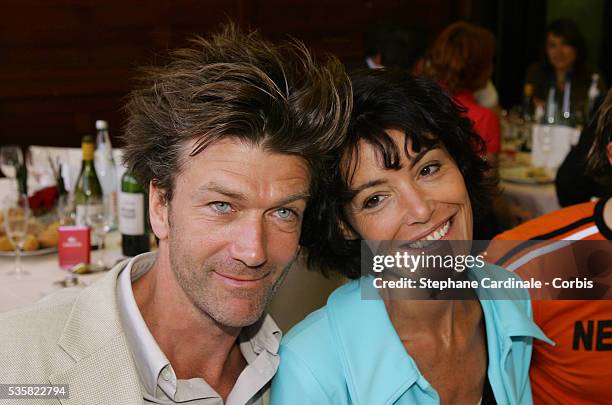 Actors Philippe Caroit and Caroline Tresca attend the Lacoste Lunch at Roland Garros village during the 2004 French Open Tennis tournament.