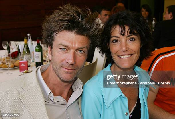 Actors Philippe Caroit and Caroline Tresca attend the Lacoste Lunch at Roland Garros village during the 2004 French Open Tennis tournament.