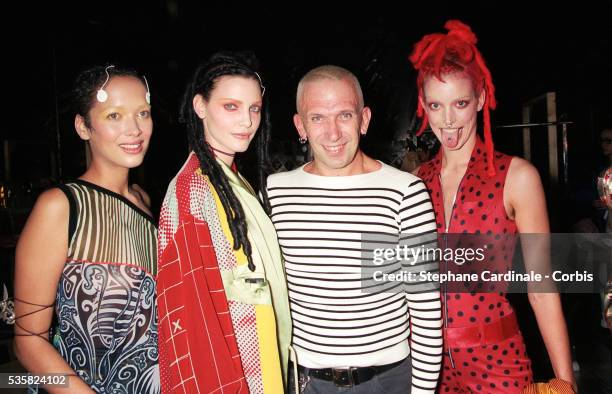 Fashion designer Jean Paul Gaultier pose with models and Nadja Auermann backstage during the Jean Paul Gaultier Ready to Wear Spring/Summer 1996 show...