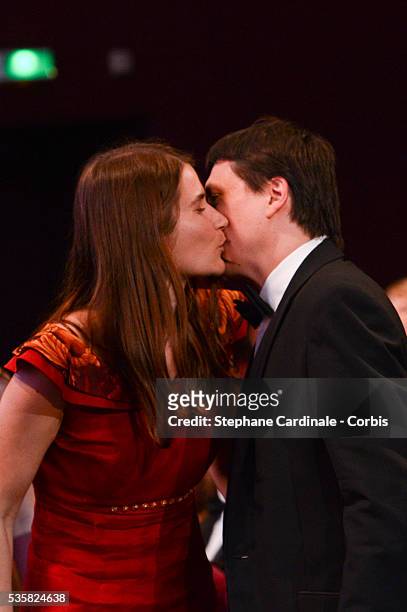 Best Actress Cristina Flutur of 'Beyond The Hills' kiss Cristian Mungiu onstage at the Closing Ceremony, during the 65th Annual Cannes Film Festival.
