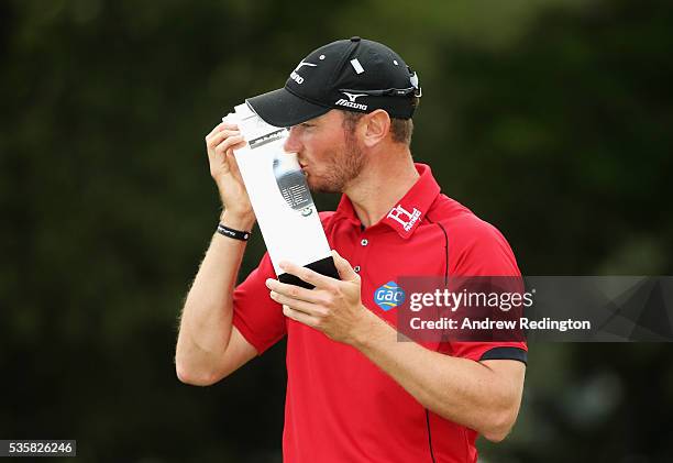 Chris Wood of England kisses the trophy following his victory during day four of the BMW PGA Championship at Wentworth on May 29, 2016 in Virginia...