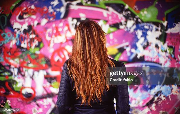 france, rear view of young woman in front of colorful mural - street art stock pictures, royalty-free photos & images