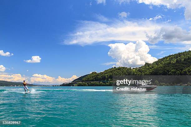 man waterskiing, worthersee, austria - wasserski stock-fotos und bilder