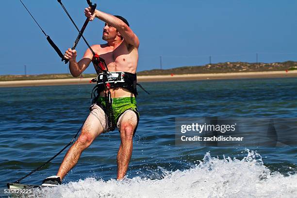 usa, texas, south padre island, gulf of mexico, close-up shot of young man kiteboarding - padre single stock-fotos und bilder