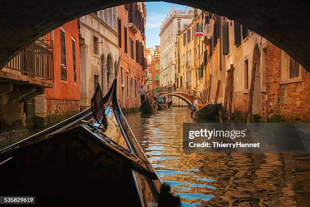 italy, veneto, venice, gondola under bridge - venedig stock-fotos und bilder