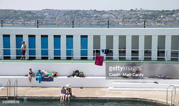 Bathers enjoy the fine weather at the recently reopened Jubilee Pool lido in Penzance on May 30, 2016 in Cornwall, England. The Grade II Listed Art...