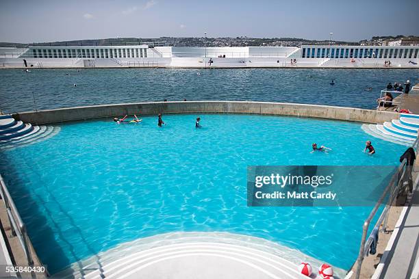 Bathers enjoy the fine weather at the recently reopened Jubilee Pool lido in Penzance on May 30, 2016 in Cornwall, England. The Grade II Listed Art...