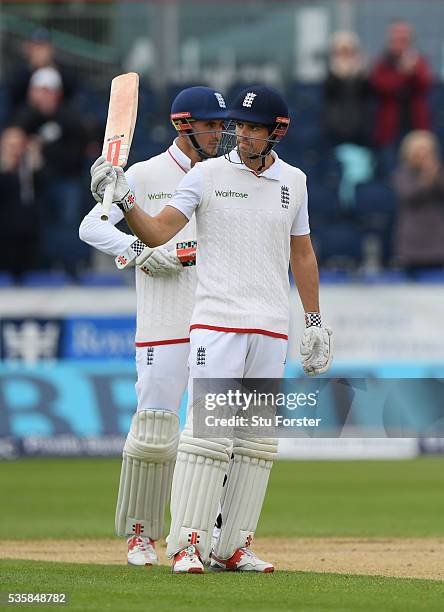 England batsman Alastair Cook raises his bat after reaching 10,000 test runs during day four of the 2nd Investec Test match between England and Sri...