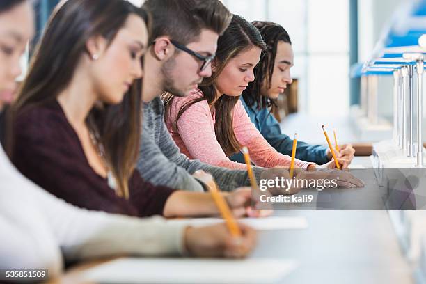 group of teenagers taking a test - gymnasieexamen bildbanksfoton och bilder