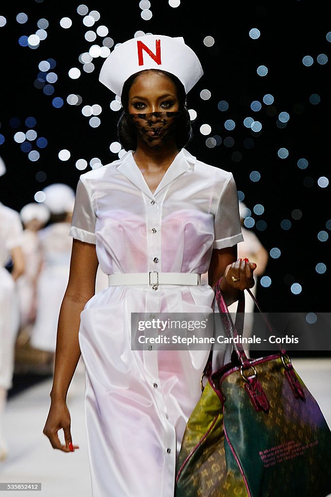 Model Naomi Campbell presents a creation from the Louis Vuitton
