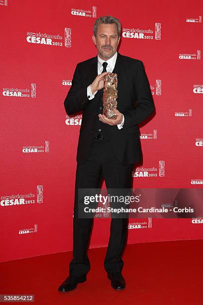 Kevin Costner poses with his trophy after receiving a lifetime achievement award during the Cesar Film Awards 2013 at Theatre du Chatelet, in Paris.