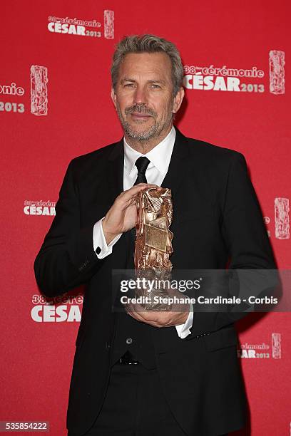 Kevin Costner poses with his trophy after receiving a lifetime achievement award during the Cesar Film Awards 2013 at Theatre du Chatelet, in Paris.