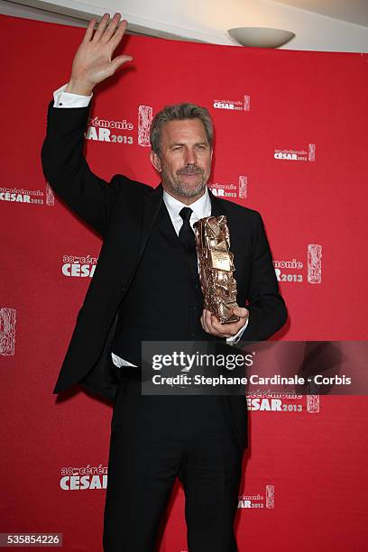 Kevin Costner poses with his trophy after receiving a lifetime achievement award during the Cesar Film Awards 2013 at Theatre du Chatelet, in Paris.