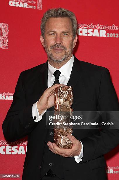 Kevin Costner poses with his trophy after receiving a lifetime achievement award during the Cesar Film Awards 2013 at Theatre du Chatelet, in Paris.