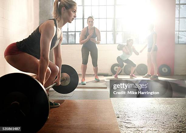 strong female preparing for deadlift - only women gym stock pictures, royalty-free photos & images