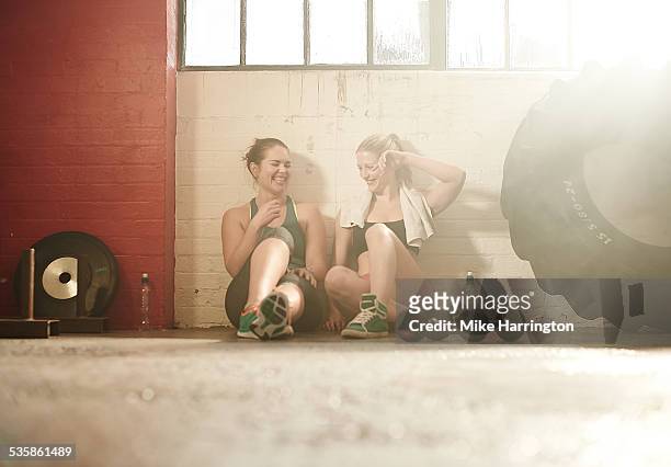 friends taking break after workout in gym - gym resting stock pictures, royalty-free photos & images