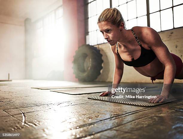 toned female performing press up - woman press ups stock pictures, royalty-free photos & images