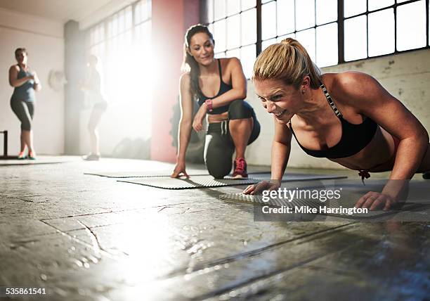 young toned female working out in gym - teacher trigger stock pictures, royalty-free photos & images