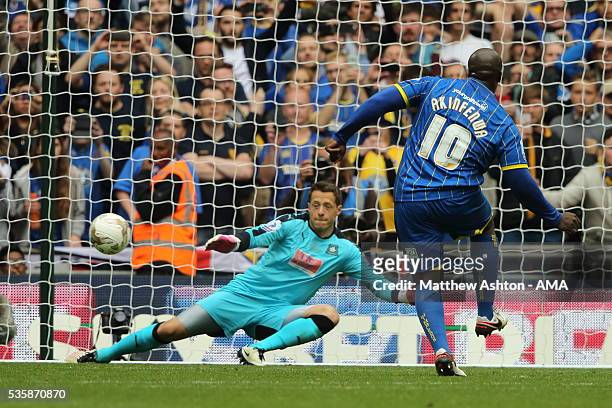 Adebayo Akinfenwa of AFC Wimbledon scores a goal from the penalty spot to make it 2-0 during the Sky Bet League Two Play Off Final between Plymouth...