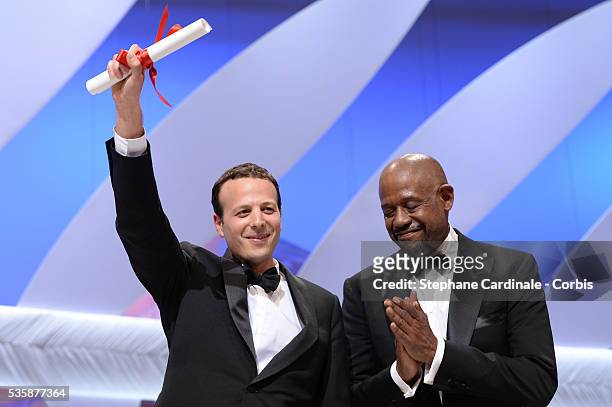 Mexican director Amat Escalante receives the best director award for 'Heli' as actor Forest Whitaker of 'Zulu' watches on stage at the 'Inside...