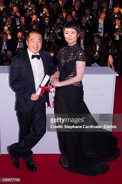 Director Jia Zhangke, winner of 'Prix du Scenario' for 'Tian Zhu Ding' , and actress Tao Zhao attend the 'Palme D'Or Winners Photocall' during the...