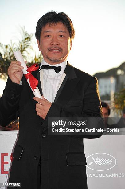 Director Hirokazu Koreeda poses with the 'Prix du jury' for 'Soshite Chichi Ni Naru' at the 'Palme D'Or Winners Photocall' during the 66th Cannes...