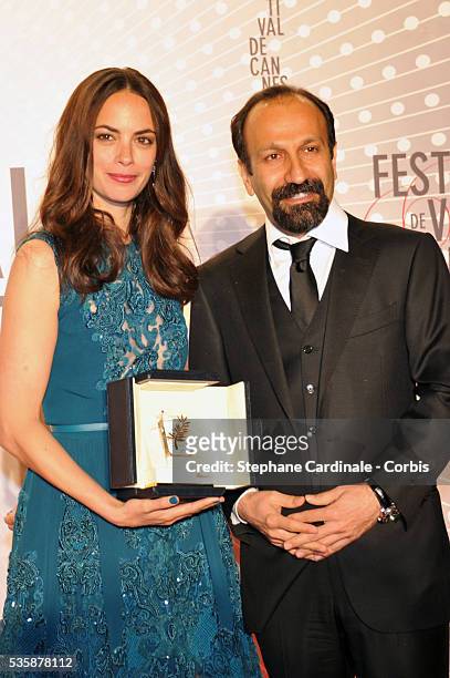 Actress Berenice Bejo, awarded with the Prix d'Interpretation Feminine , and director Asghar Farhadi attend the 'Palme D'Or Winners dinner' during...