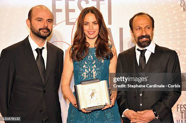 Actress Berenice Bejo, awarded with the Prix d'Interpretation Feminine , poses with actor Ali Mosaffa and director Asghar Farhadi at the 'Palme D'Or...