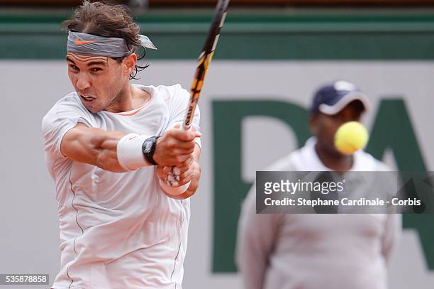 Rafael Nadal of Spain plays a backhand in his Men's Singles match against Fabio Fognini of Italy during day seven of the French Open at Roland Garros...