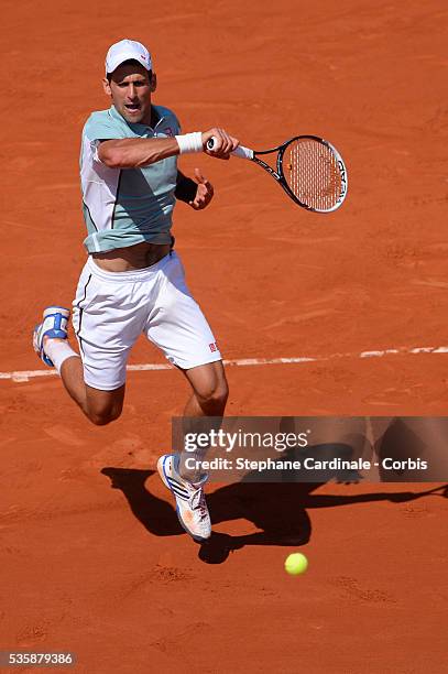 Novak Djokovic of Serbia plays a forehand during the men's singles semi-final match against Rafael Nadal of Spain on day thirteen of the French Open...