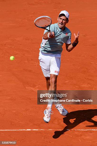 Novak Djokovic of Serbia plays a forehand during the men's singles semi-final match against Rafael Nadal of Spain on day thirteen of the French Open...