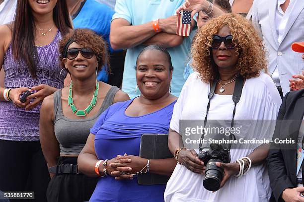 Venus Williams, Isha Price and Oracene Price the mother of Serena Williams of United States of America looks on after her Women's singles final match...