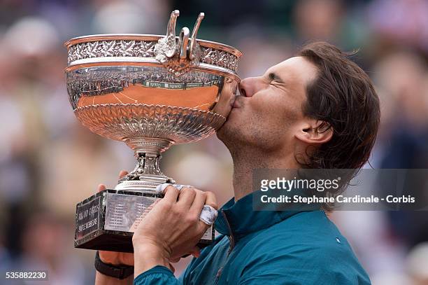 Rafael Nadal of Spain kisses the Coupe des Mousquetaires trophy as he celebrates victory in the men's singles final against David Ferrer of Spain...