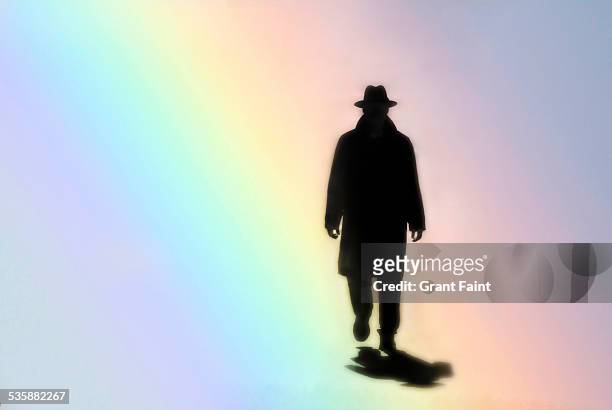 man walking in rainbow - overcoat stock pictures, royalty-free photos & images