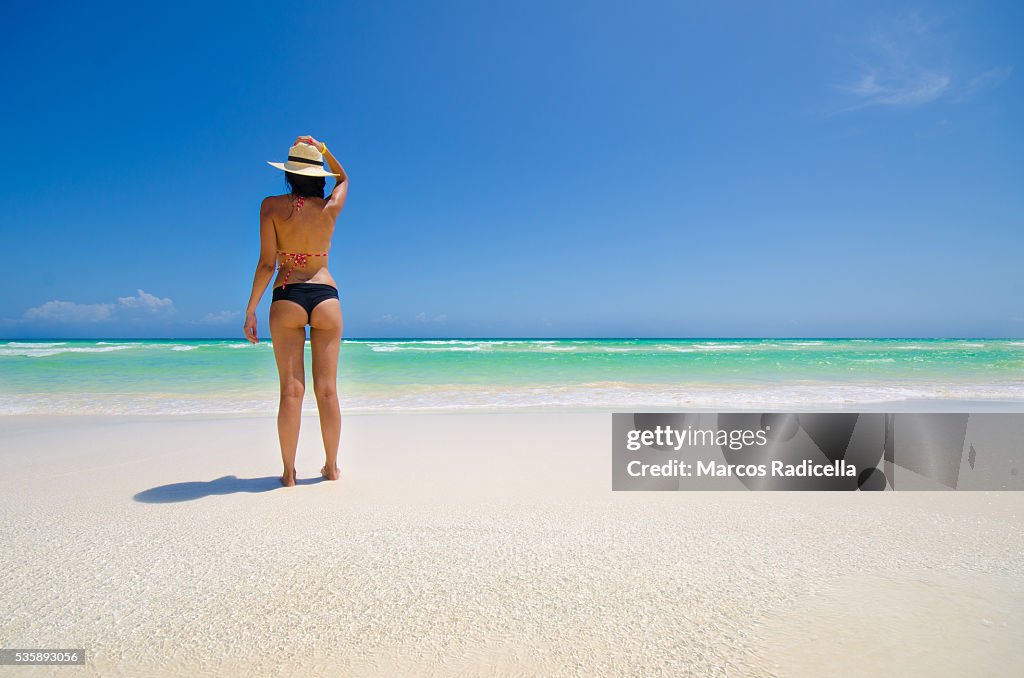 Woman staring at the sea, Cayo Coco, Cuba.