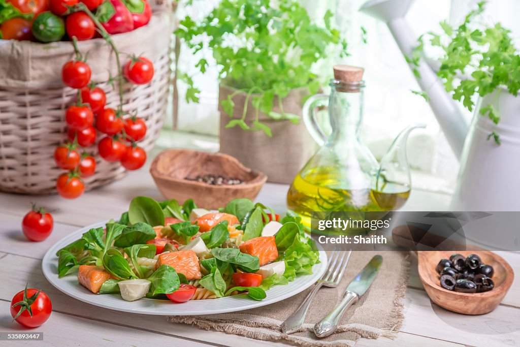 Healthy salad with fresh vegetables and salmon