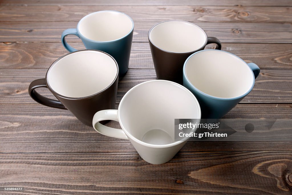 Empty cups on wood background