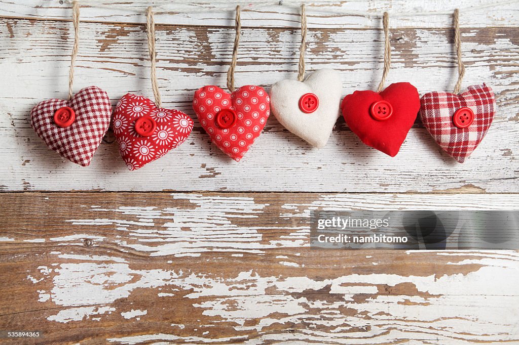 Fabric hearts on a wooden background