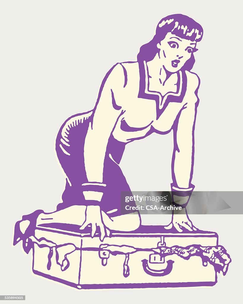 Woman Kneeling on Full Suitcase to Close It
